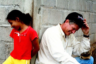 Image of Dr. Paul Major with a coy Honduran girl, much like the future Residents of Nanny's Casa.